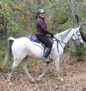 woman riding a white horse