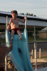 Child sliding down a pool slide