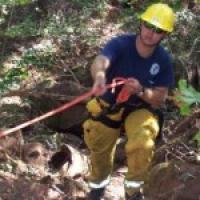 firefighter with a rope in the woods 