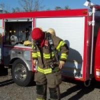 firefighter in uniform in front of a truck